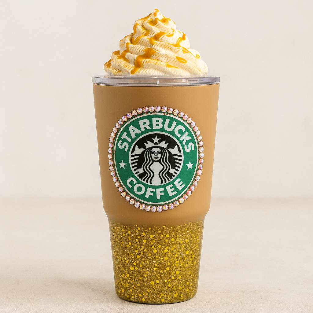 Starbucks coffee cup with yellow speckled design and whipped cream on a beige background