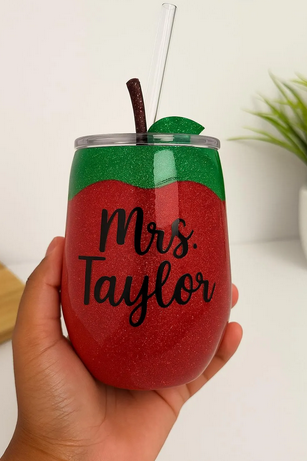 Custom apple-shaped glitter tumbler with “Mrs. Taylor” text, designed for teachers – handmade by Lavish Designs by Jelisha