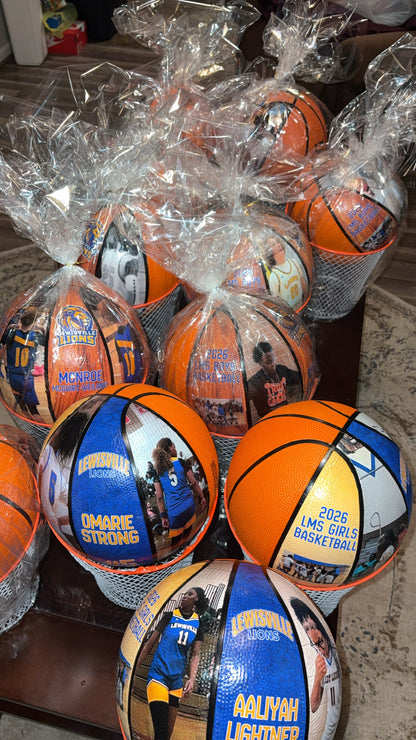 Basketballs with personalized names and numbers in clear plastic packaging.