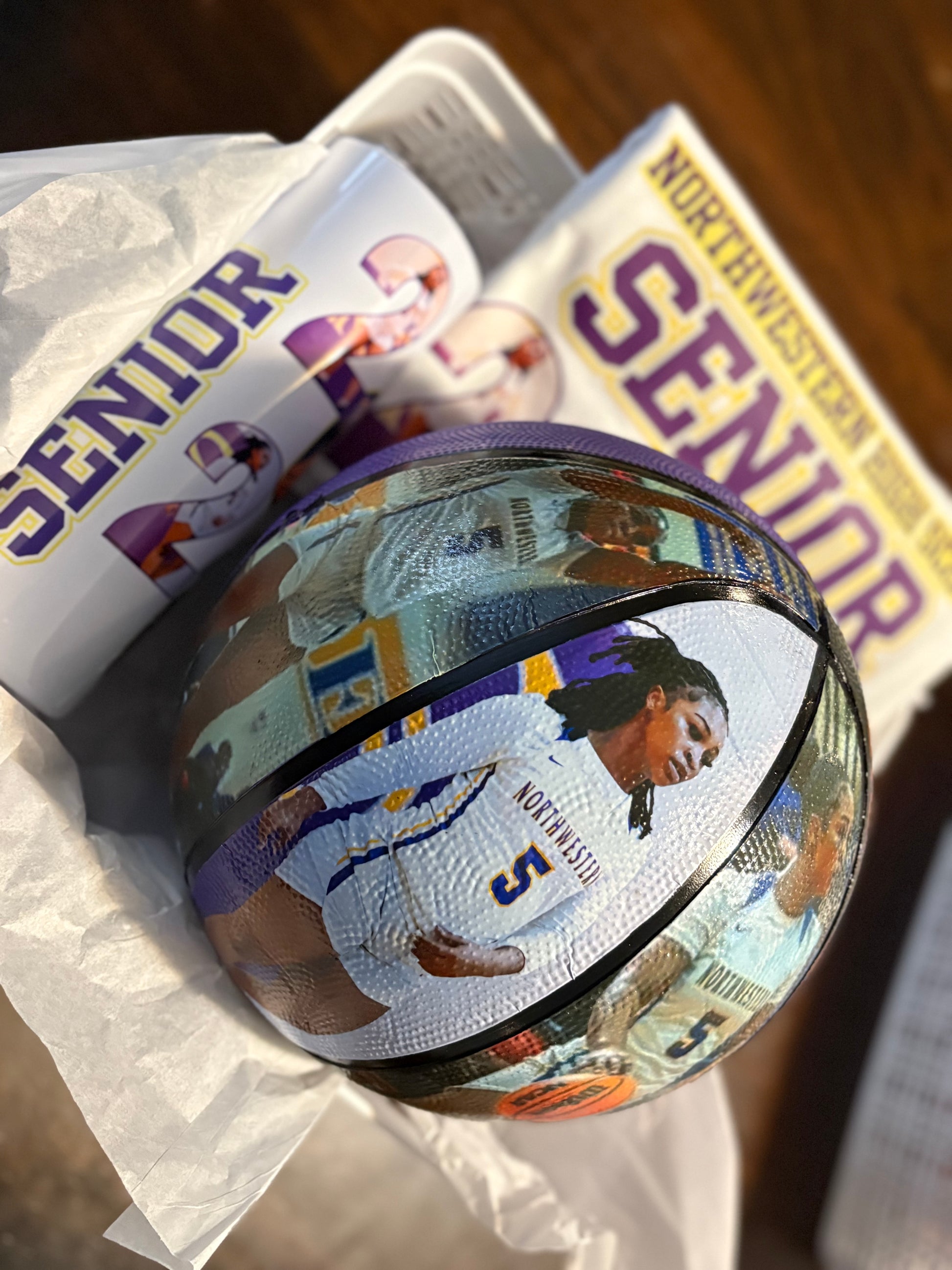 Basketball with a player's image on it, placed on top of 'Northwestern Senior' yearbooks.