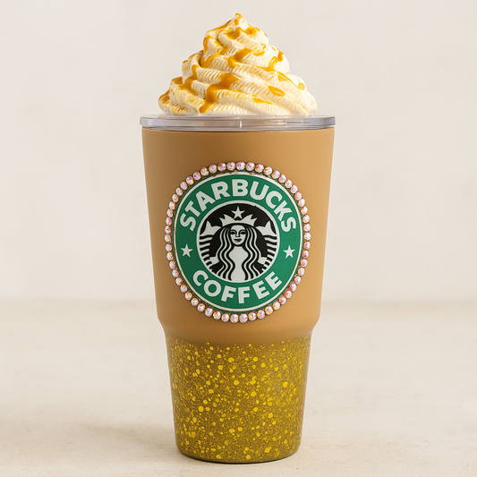 Starbucks coffee cup with yellow speckled design and whipped cream on a beige background